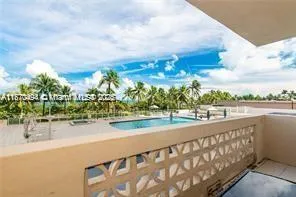 a view of a swimming pool and an outdoor seating