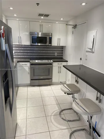 a kitchen with stainless steel appliances granite countertop a sink and cabinets