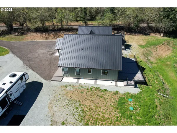a backyard of a house with wooden floor and fence