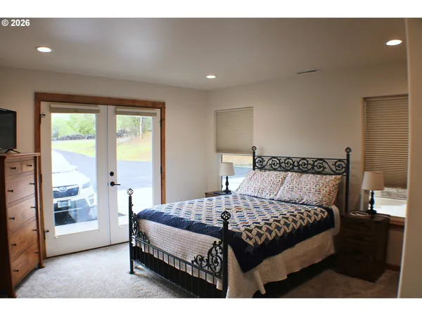 a bedroom with a bed and a mirror
