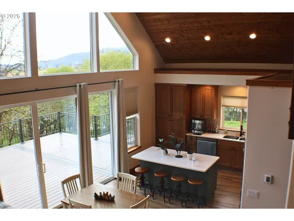 a open kitchen with a sink and wooden floor
