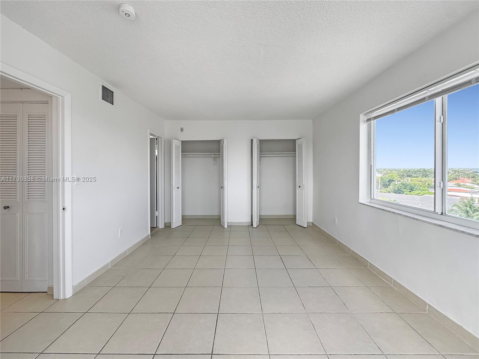 8001 Crespi Boulevard, Unit 7A Miami Beach, FL 33141 - Photo 14 of 25 a view of an empty room with a window