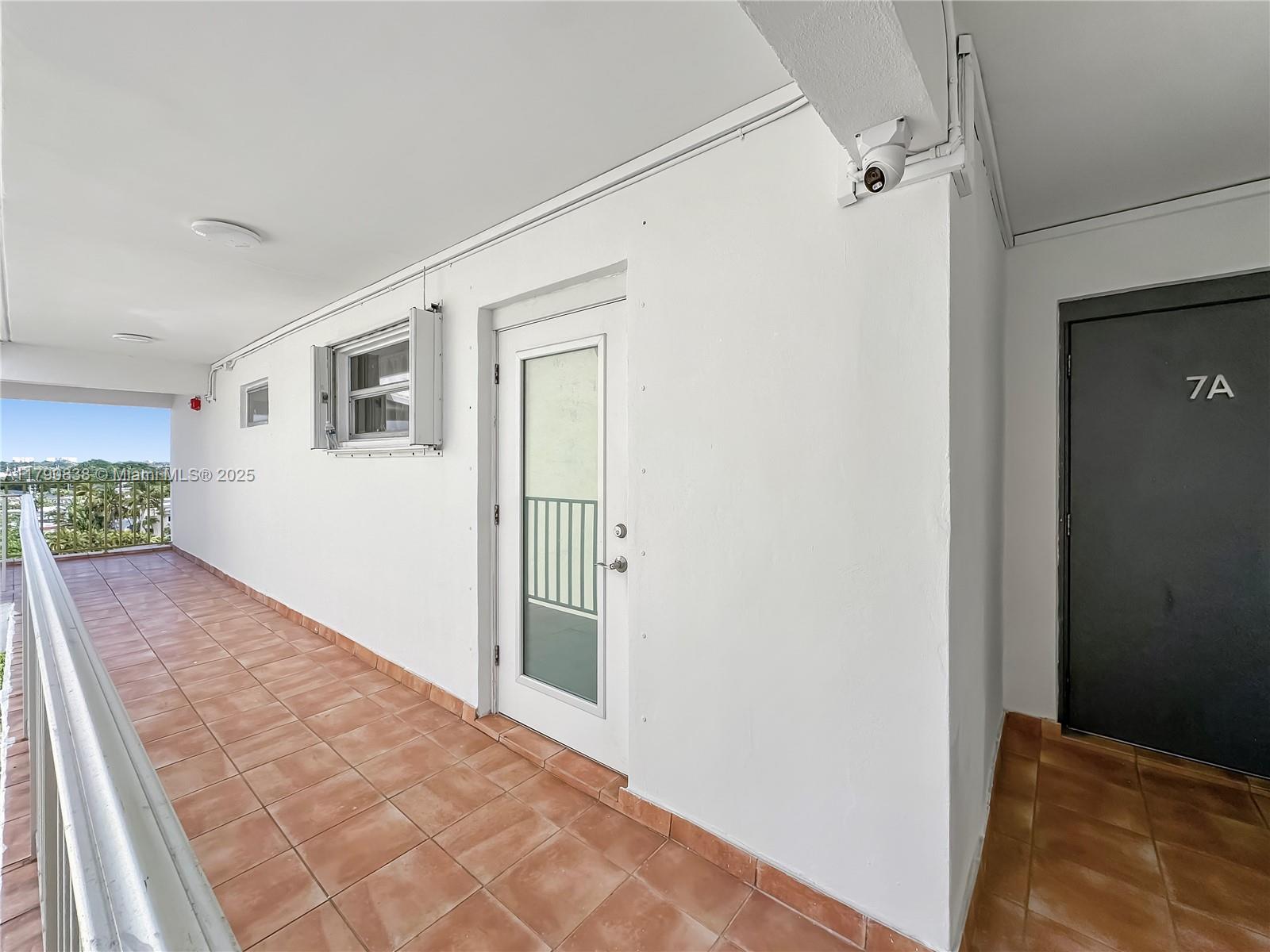 8001 Crespi Boulevard, Unit 7A Miami Beach, FL 33141 - Photo 21 of 25 a view of a big room with wooden floor and windows