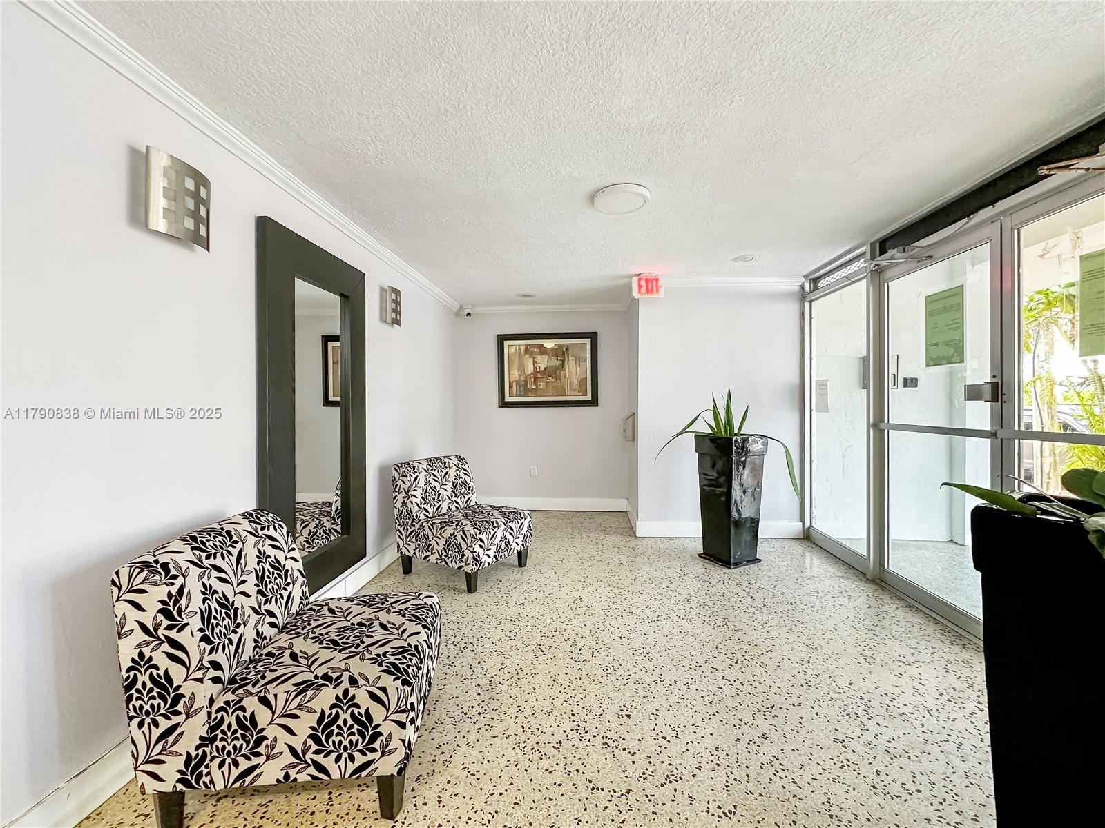 8001 Crespi Boulevard, Unit 7A Miami Beach, FL 33141 - Photo 22 of 25 a bedroom with furniture and large windows