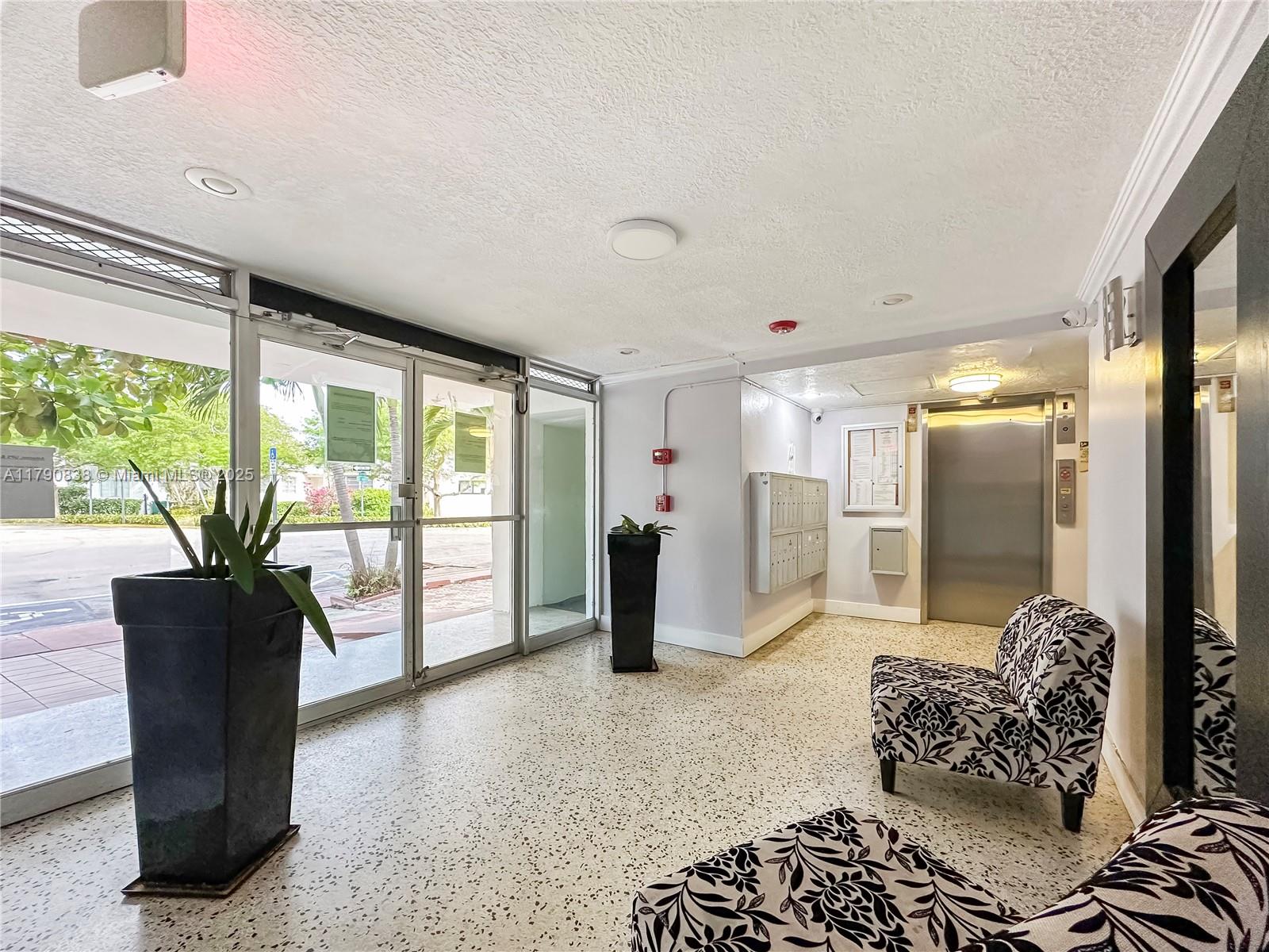 8001 Crespi Boulevard, Unit 7A Miami Beach, FL 33141 - Photo 23 of 25 a living room with furniture and a large window