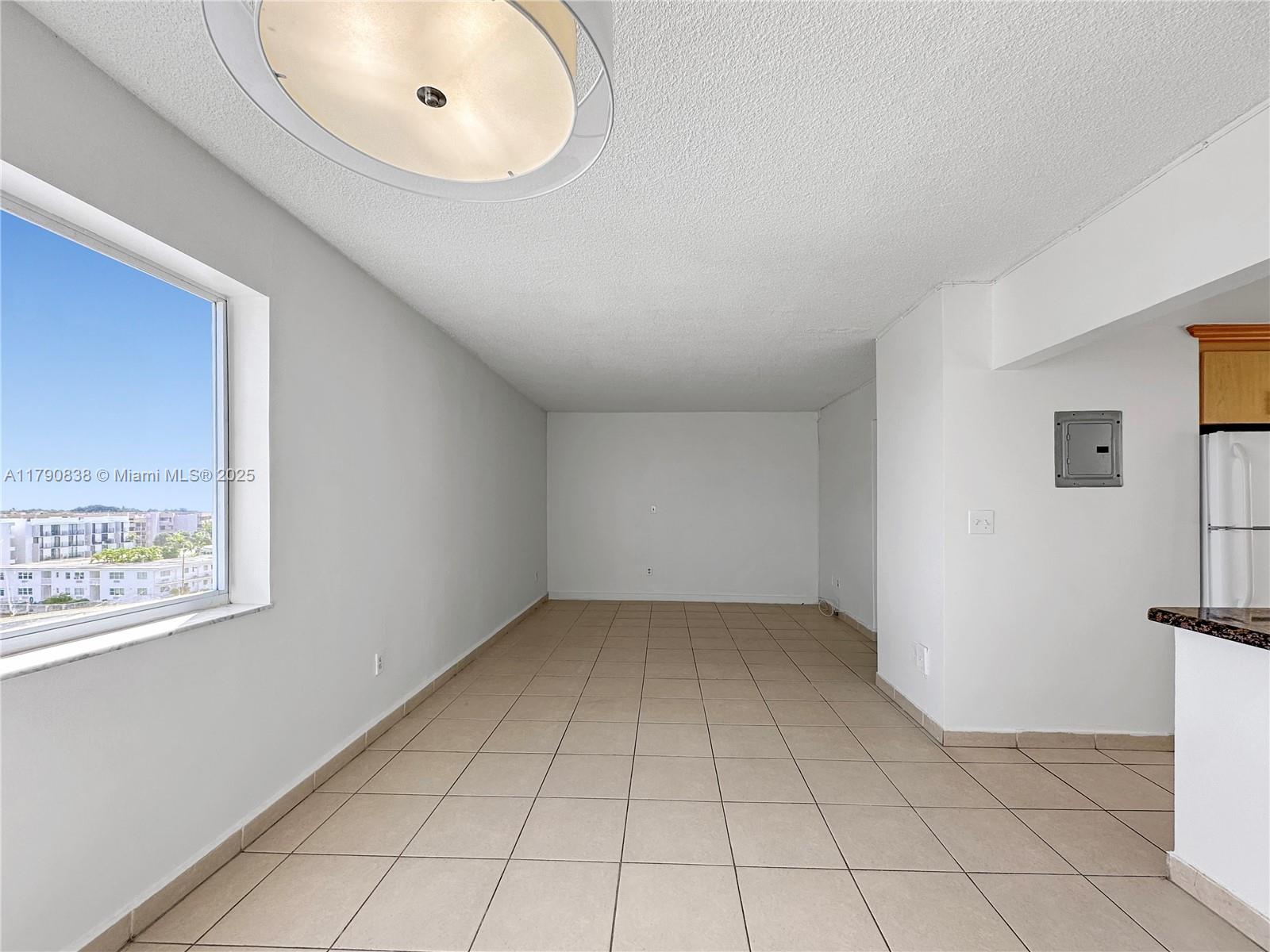 8001 Crespi Boulevard, Unit 7A Miami Beach, FL 33141 - Photo 7 of 25 a view of an empty room with a window