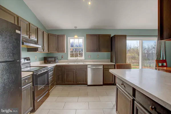 a kitchen with a sink stove and cabinets