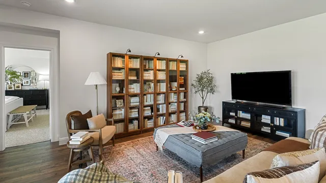 a living room with furniture kitchen view and a large window