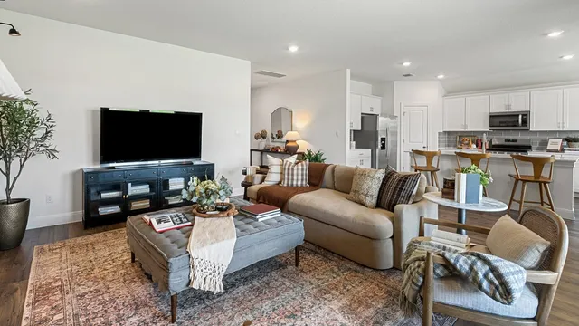 a kitchen with stainless steel appliances granite countertop a stove a sink a refrigerator a microwave and cabinets