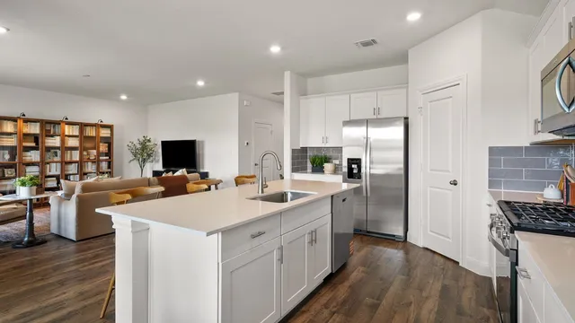 a bathroom with a glass shower door a bathtub a sink and a mirror