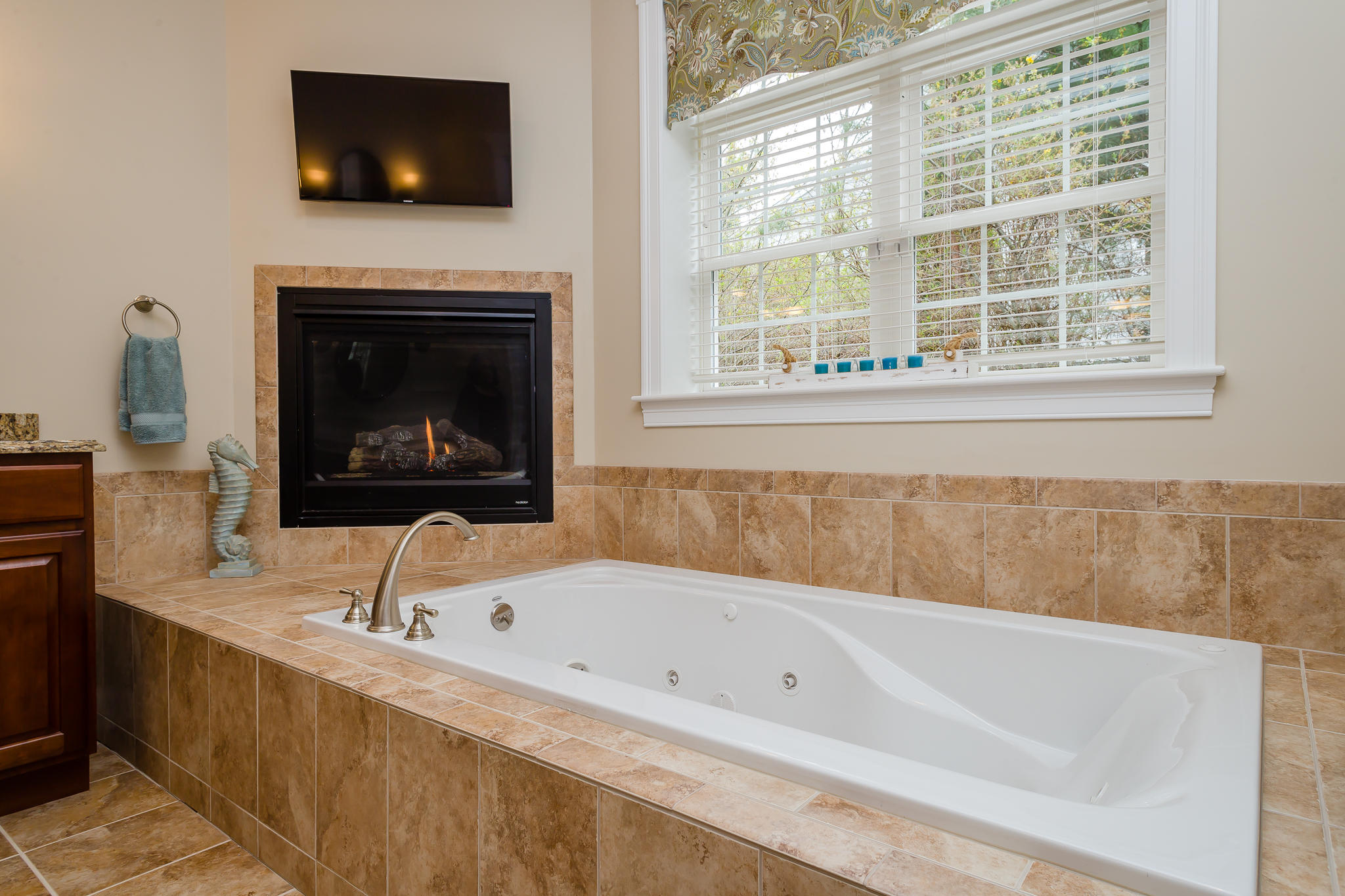 85 Palmer Road Mashpee, MA 02649 - Photo 17 of 38 a bathroom with a bathtub and a flat screen tv