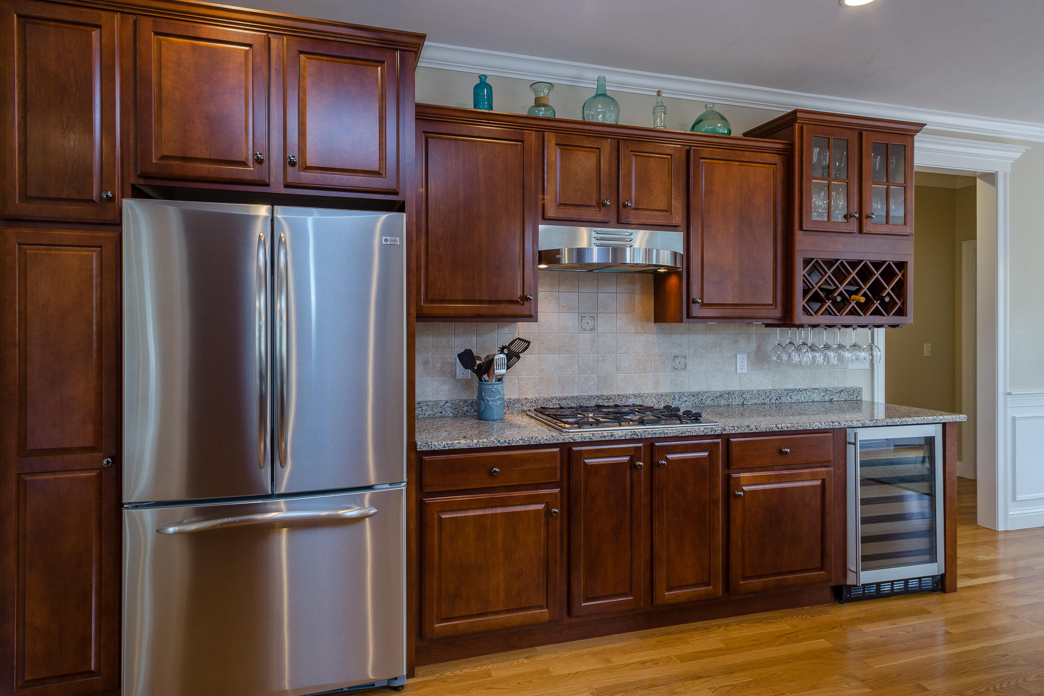85 Palmer Road Mashpee, MA 02649 - Photo 9 of 38 a kitchen with kitchen island granite countertop wooden cabinets stainless steel appliances and a sink