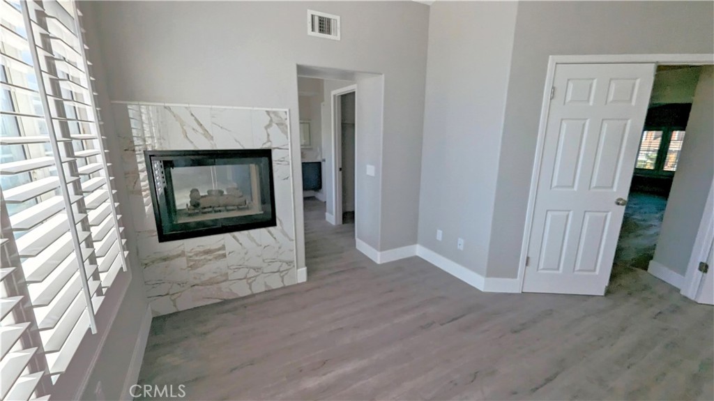 14363 Auburn Court Chino Hills, CA 91709 - Photo 22 of 27 an empty room with wooden floor fireplace and windows