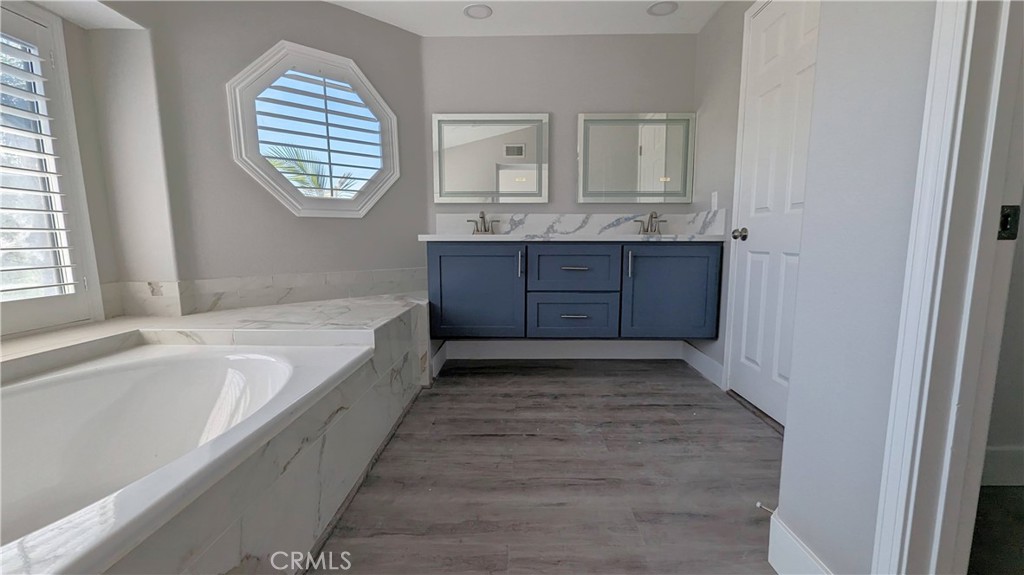 14363 Auburn Court Chino Hills, CA 91709 - Photo 23 of 27 a spacious bathroom with a granite countertop sink a mirror and a bathtub