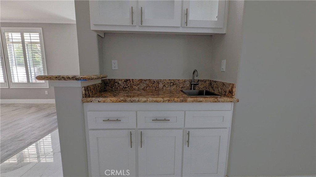 14363 Auburn Court Chino Hills, CA 91709 - Photo 9 of 27 a bathroom with a granite countertop white cabinets and a sink