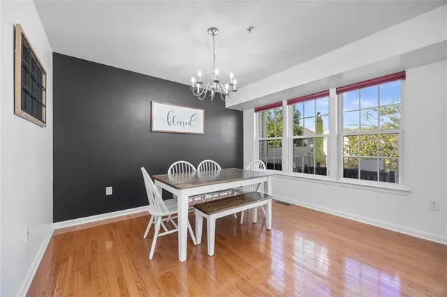 a view of a dining room with furniture wooden floor and chandelier