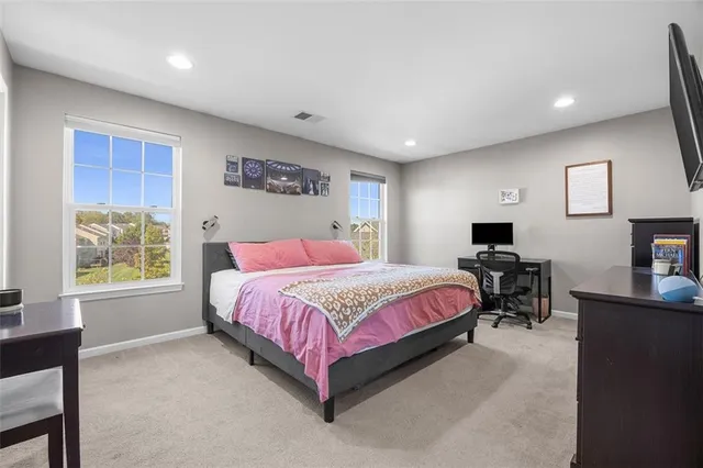 a spacious bedroom with a bed and a couch