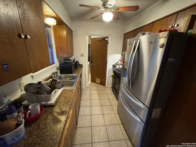 a kitchen with stainless steel appliances granite countertop a refrigerator and a sink