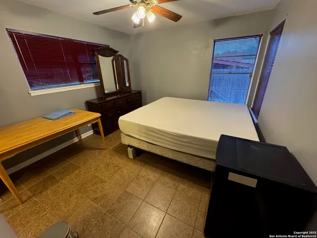 a bed room with a bed and a television