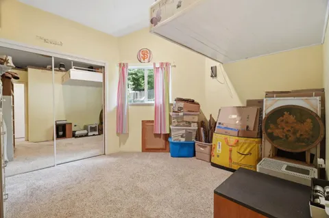a view of a bedroom with workspace and a window