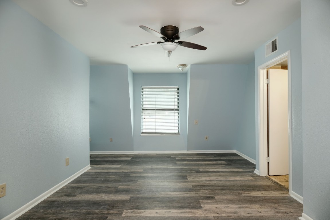 20500 Keilman Lane Pflugerville, TX 78660 - Photo 22 of 38 a view of empty room with wooden floor and fan