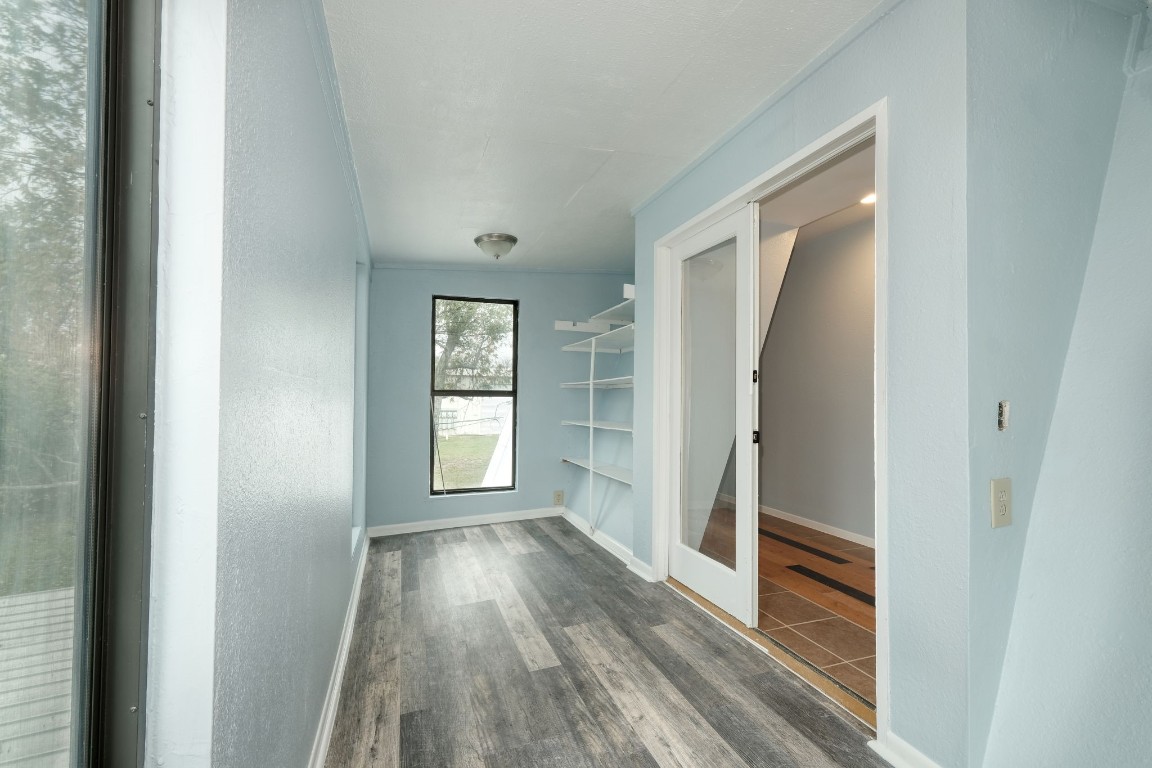 20500 Keilman Lane Pflugerville, TX 78660 - Photo 30 of 38 a view of hallway with window and wooden floor