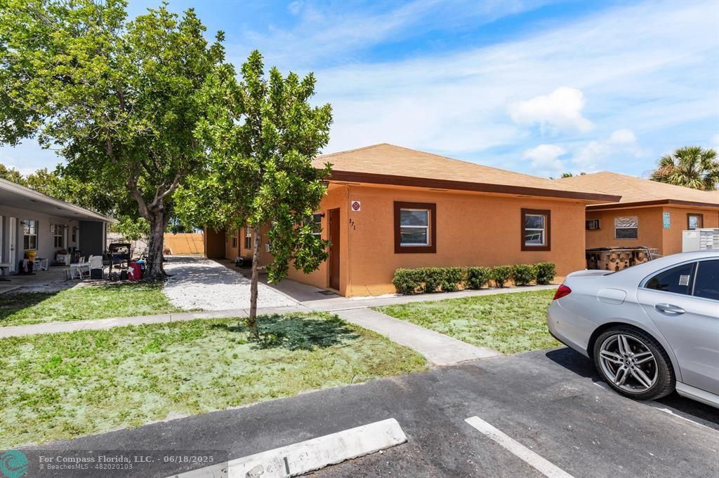 271 Southwest 1st Street, Unit 2 Deerfield Beach, FL 33441 - Photo 1 of 2 a front view of a house with a yard