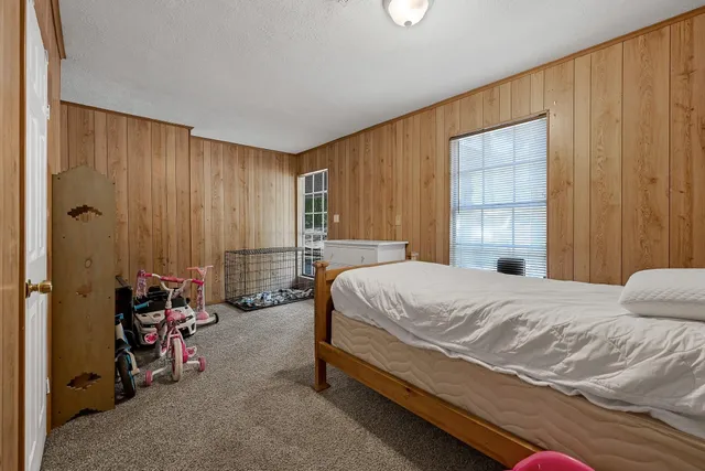 a spacious bathroom with a granite countertop sink and a mirror