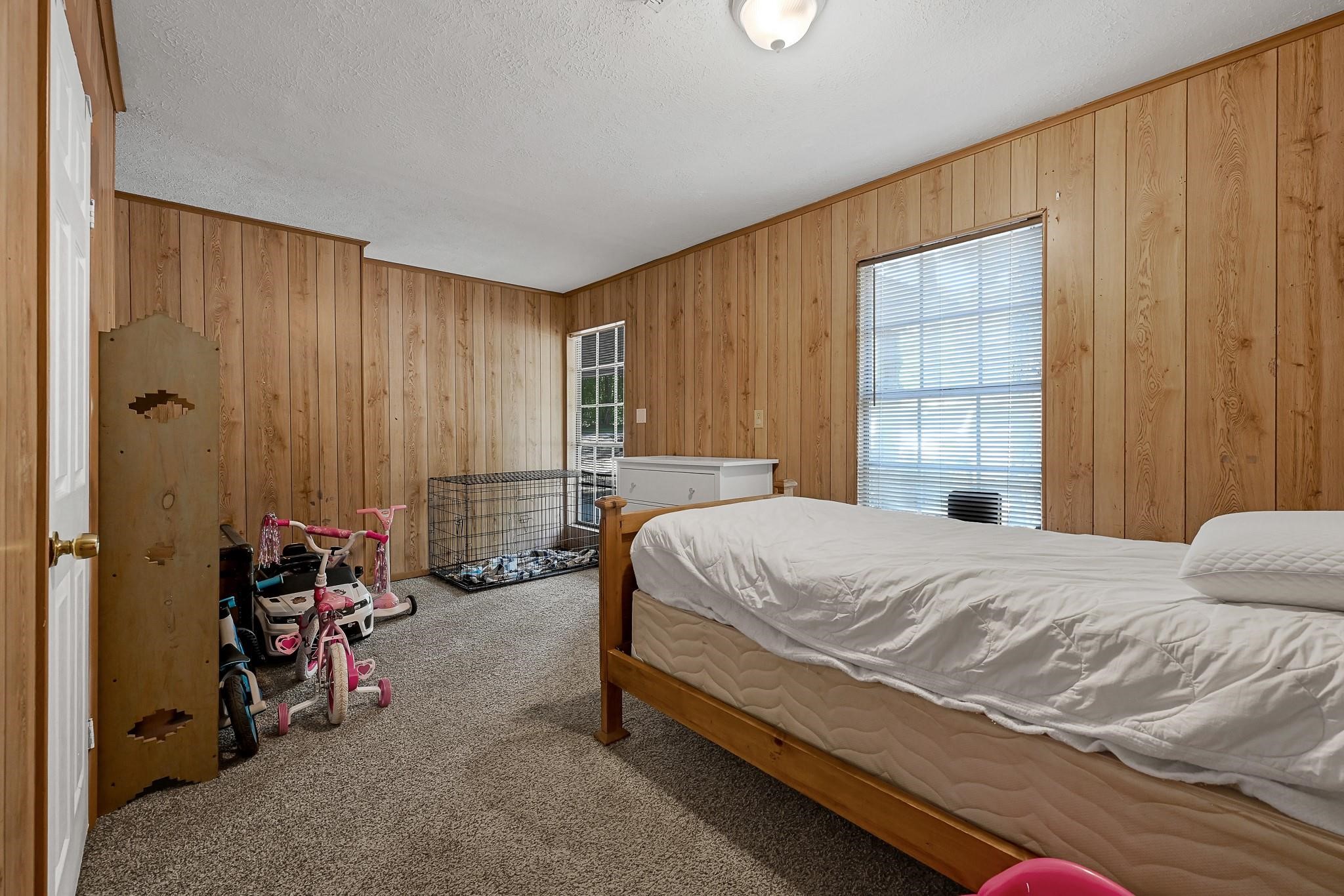 88 Gazebo Street, Unit AE Huntsville, TX 77340 - Photo 14 of 24 a bedroom with a bed and a window