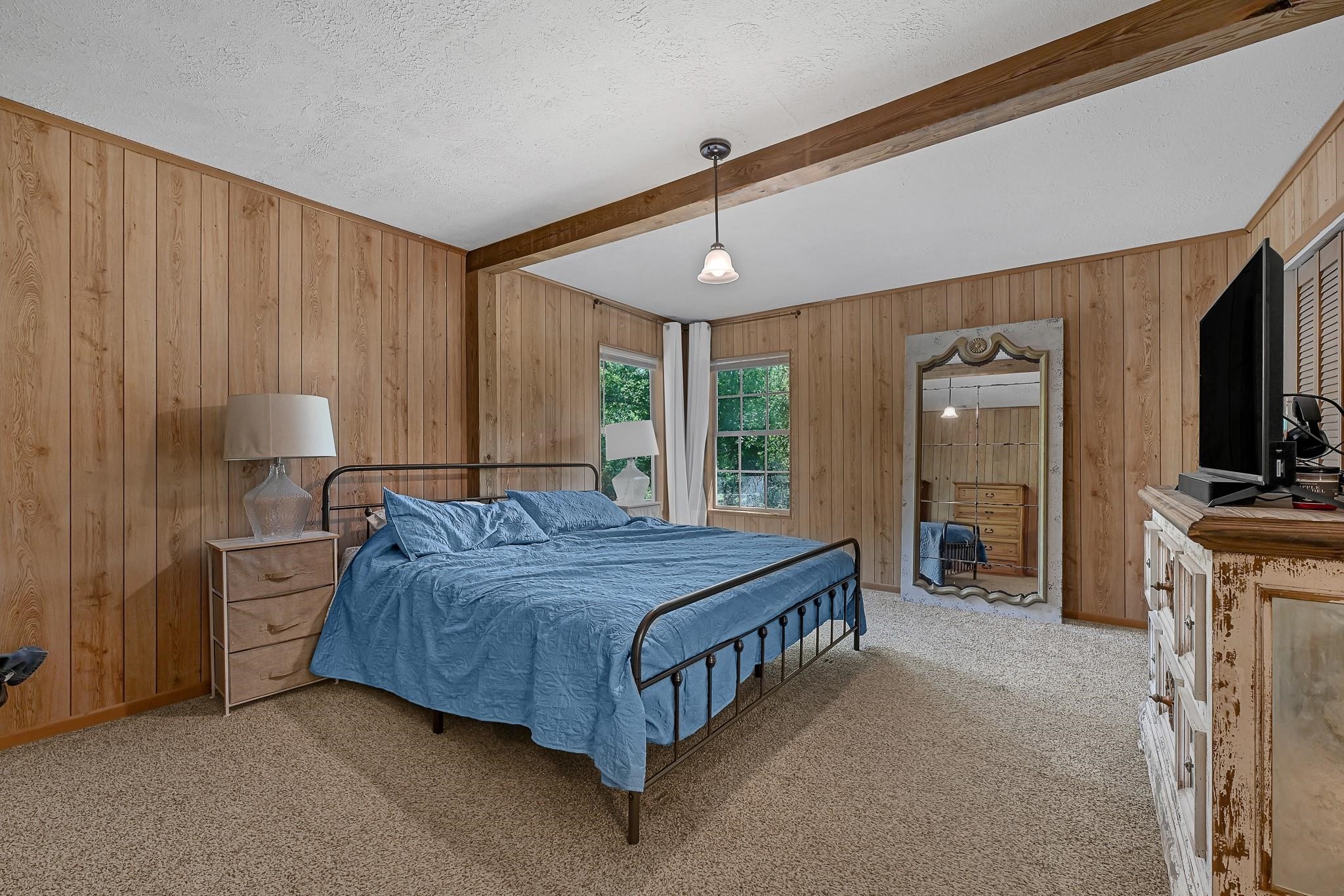 88 Gazebo Street, Unit AE Huntsville, TX 77340 - Photo 16 of 24 a bed room with a bed and a television