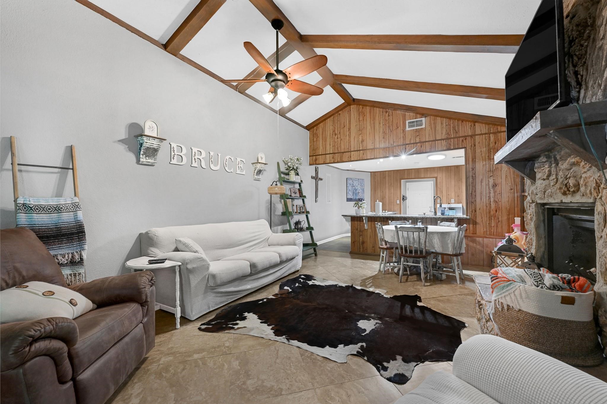 88 Gazebo Street, Unit AE Huntsville, TX 77340 - Photo 19 of 24 a living room with furniture a fireplace and a ceiling fan