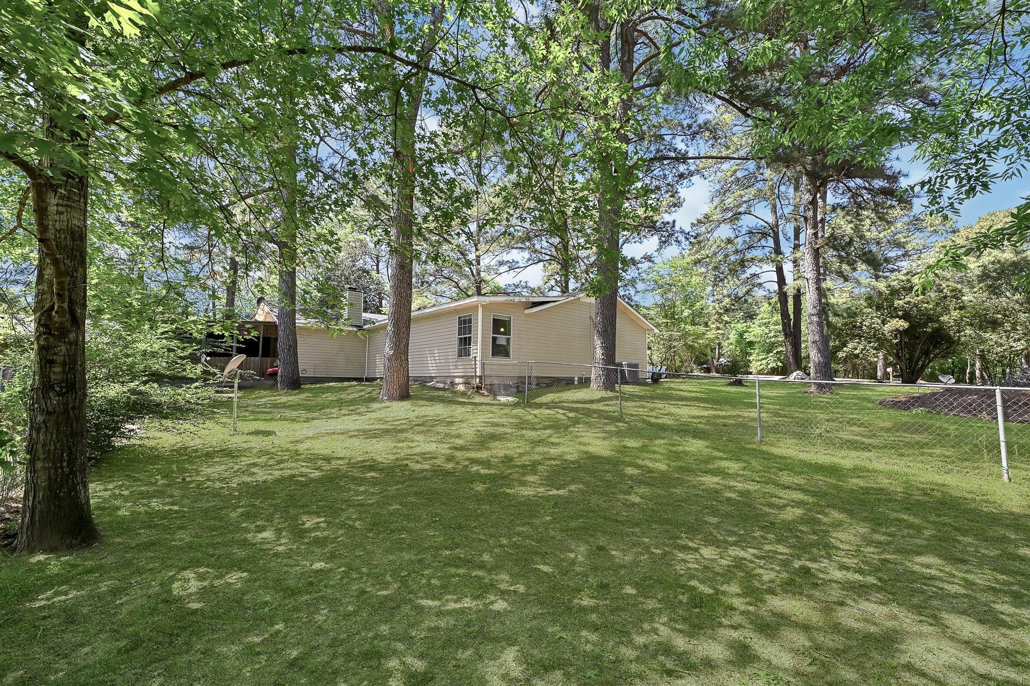 88 Gazebo Street, Unit AE Huntsville, TX 77340 - Photo 2 of 24 a backyard of a house with table and chairs