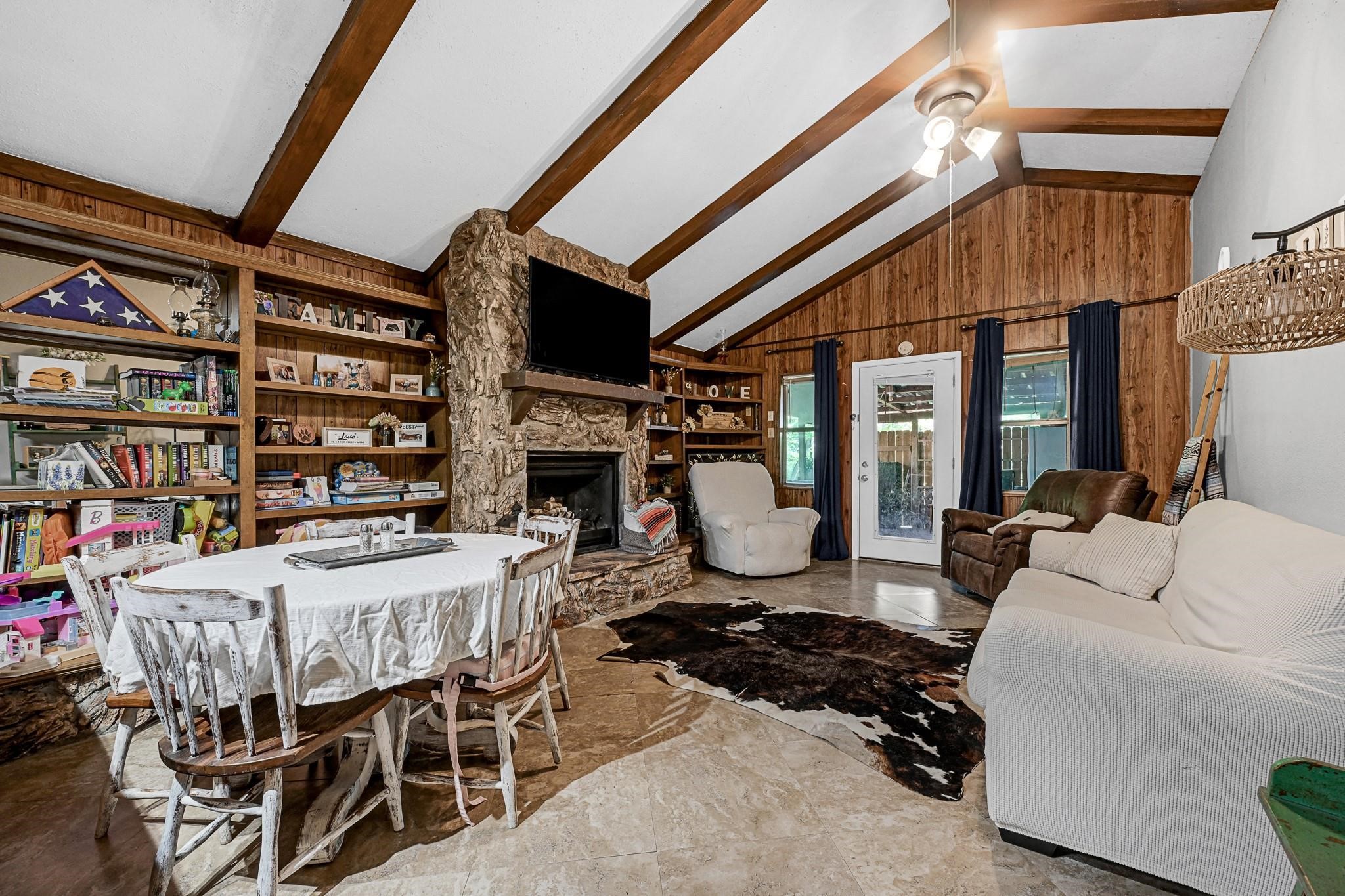 88 Gazebo Street, Unit AE Huntsville, TX 77340 - Photo 9 of 24 a living room with a couch and a bookshelf