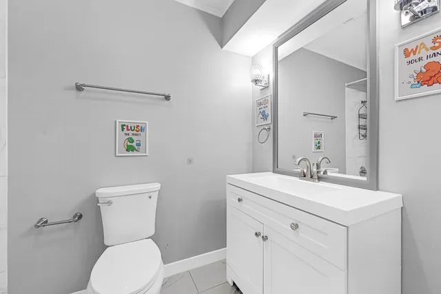 a bathroom with a sink toilet a mirror a vanity and shower