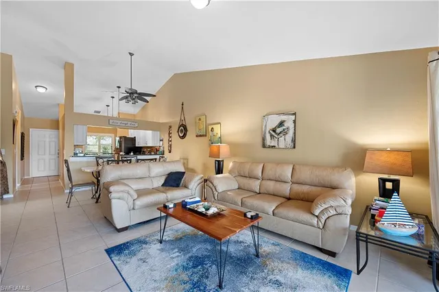 a living room with furniture a rug and a table