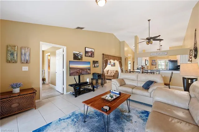 a living room with furniture a rug and a chandelier