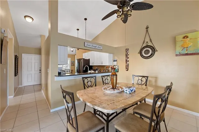 a view of a dining room with furniture and a chandelier