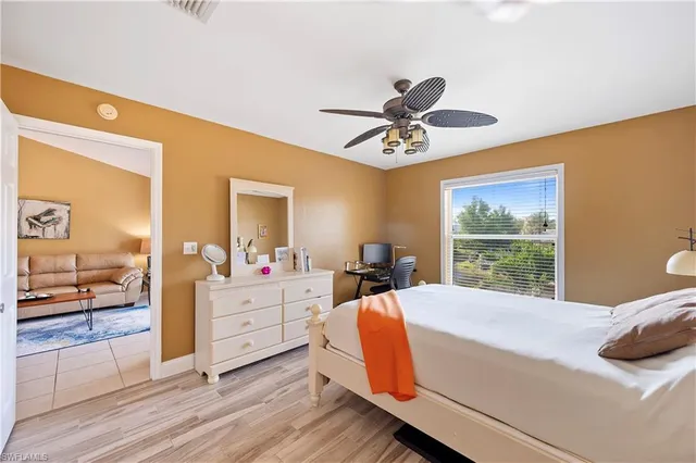 a bedroom with a bed and a large window