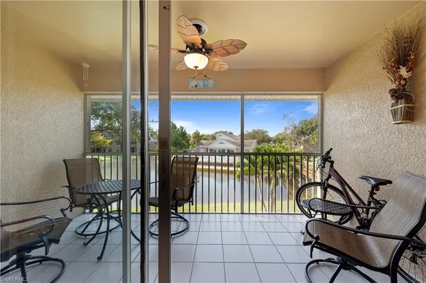 a view of a chairs and table in a balcony