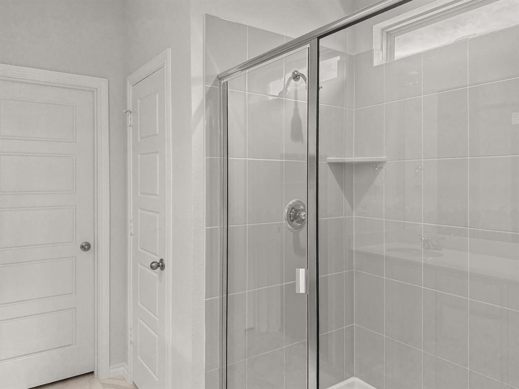 1908 Iris Road Melissa, TX 75454 - Photo 16 of 30 a bathroom with a glass shower door
