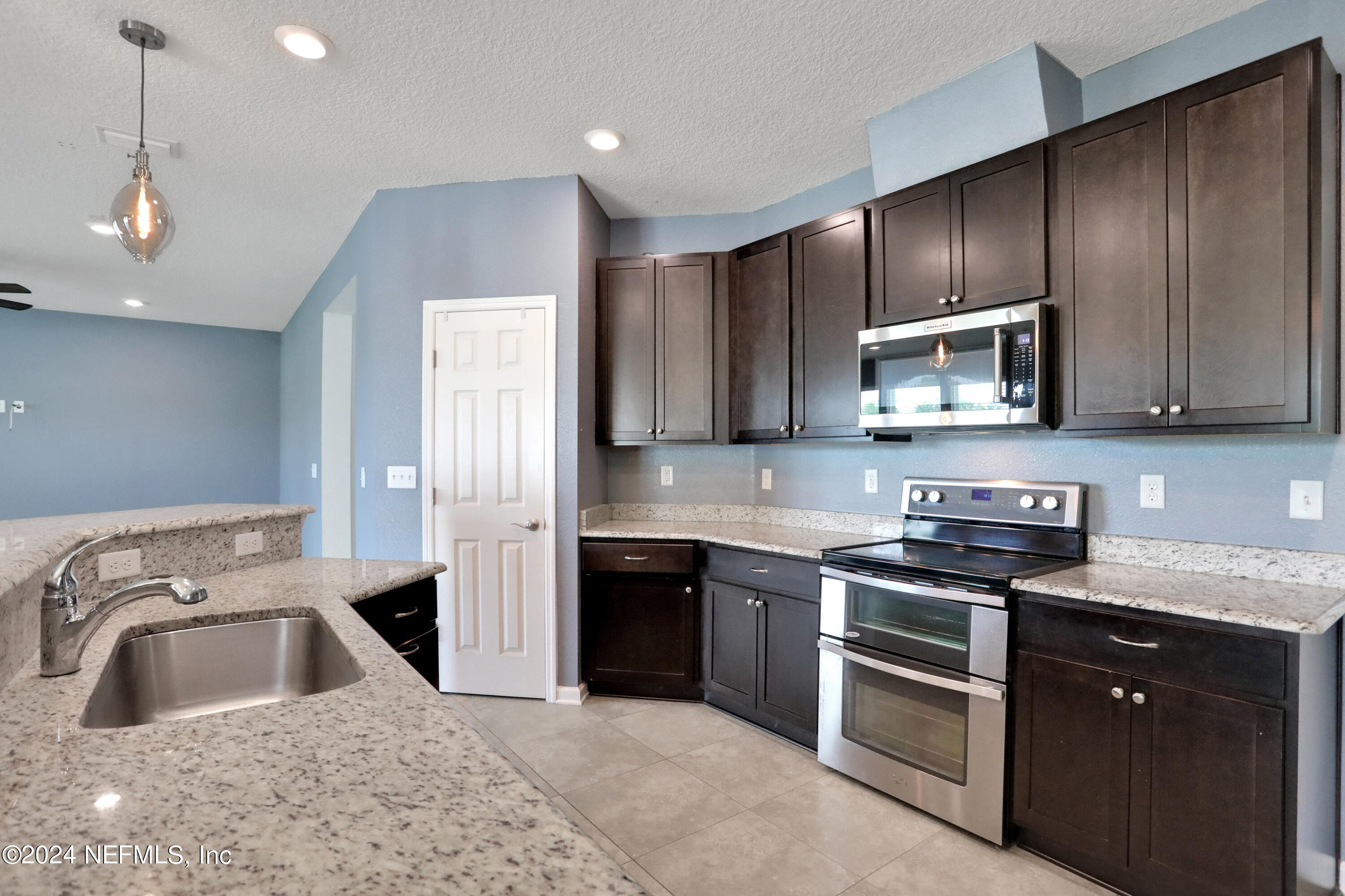 16055 Hutton Lane Jacksonville, FL 32218 - Photo 12 of 28 a kitchen with stainless steel appliances granite countertop a sink stove and refrigerator