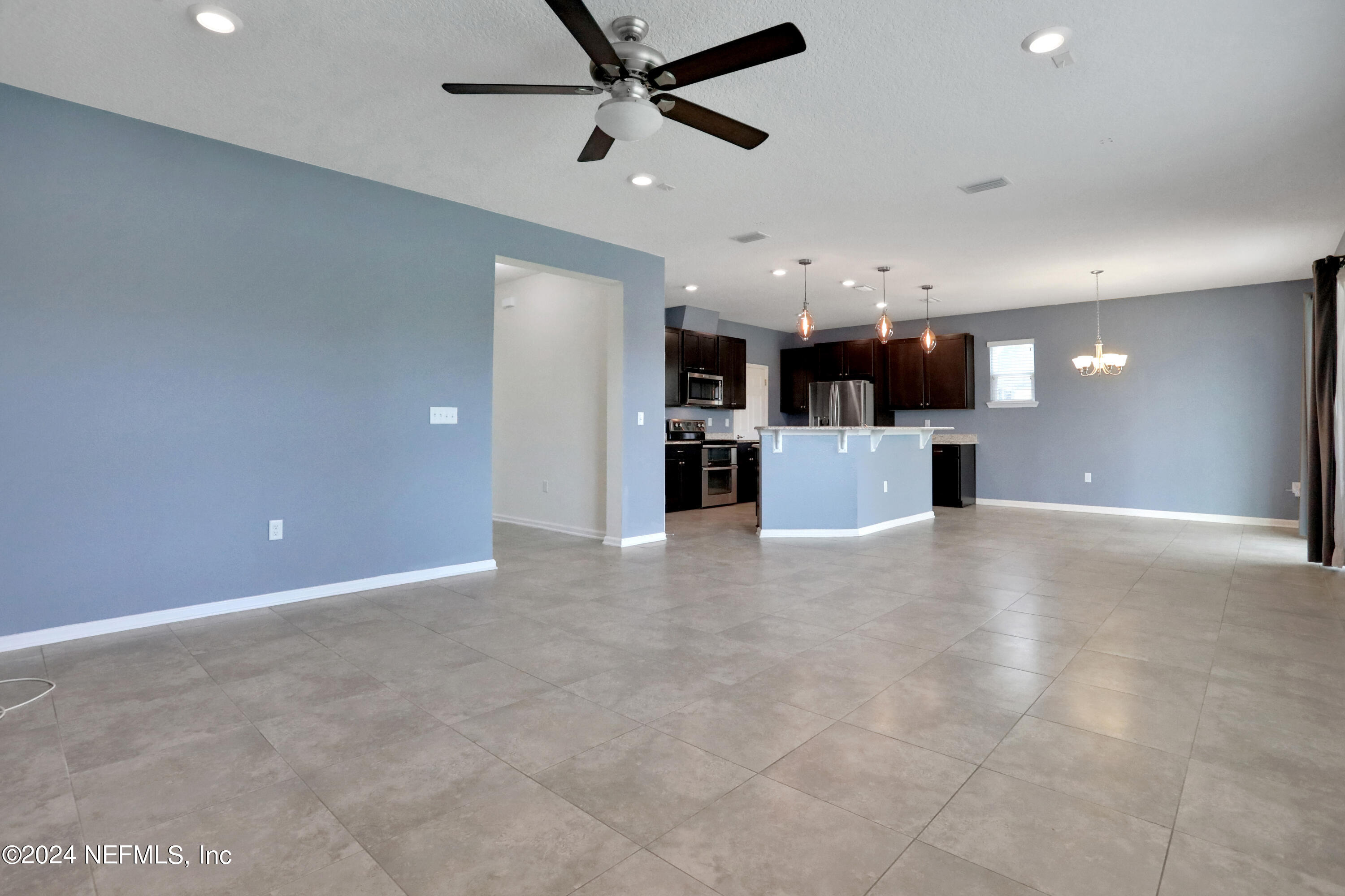 16055 Hutton Lane Jacksonville, FL 32218 - Photo 14 of 28 an empty room with kitchen and a ceiling fan