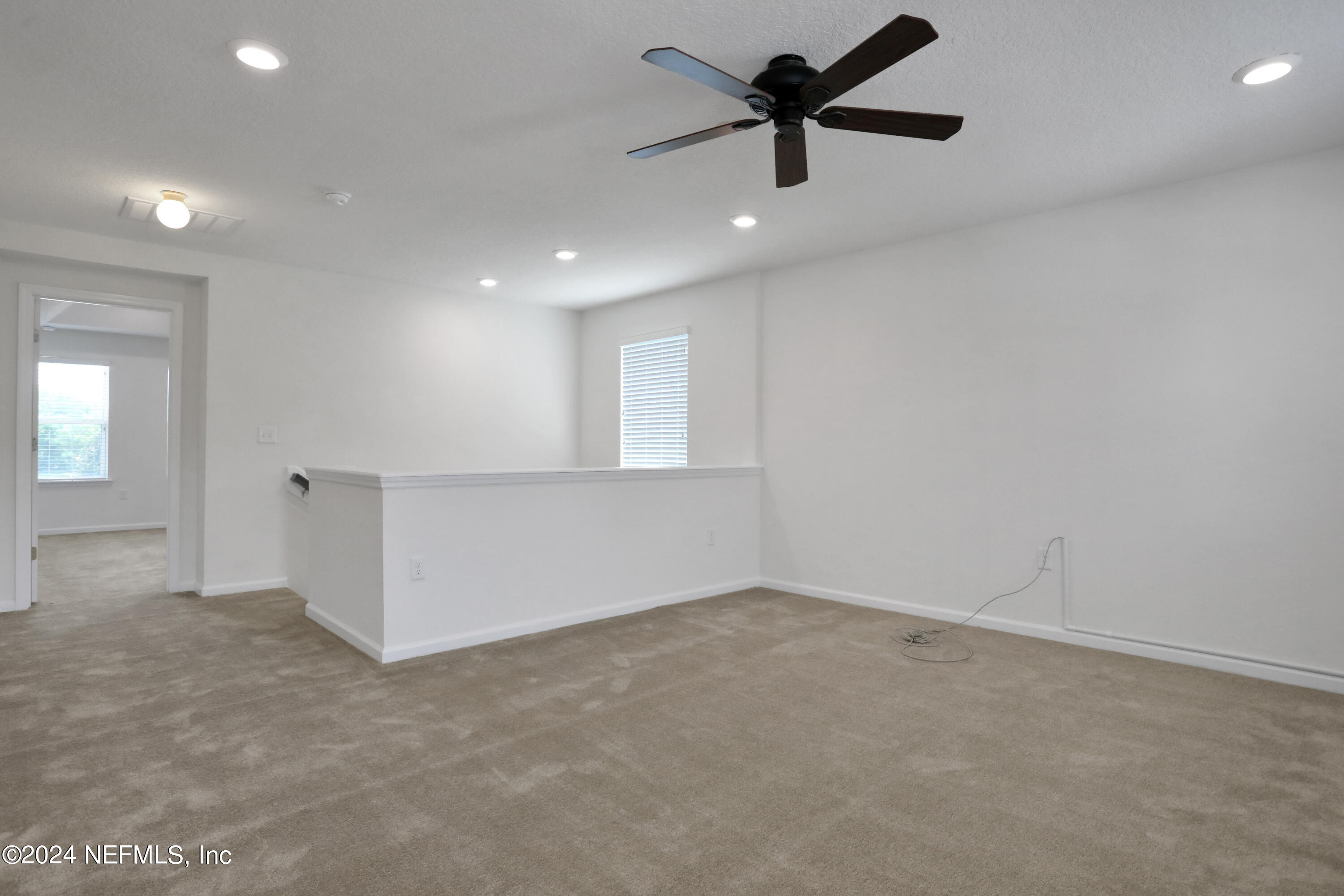16055 Hutton Lane Jacksonville, FL 32218 - Photo 18 of 28 an empty room with fan and windows