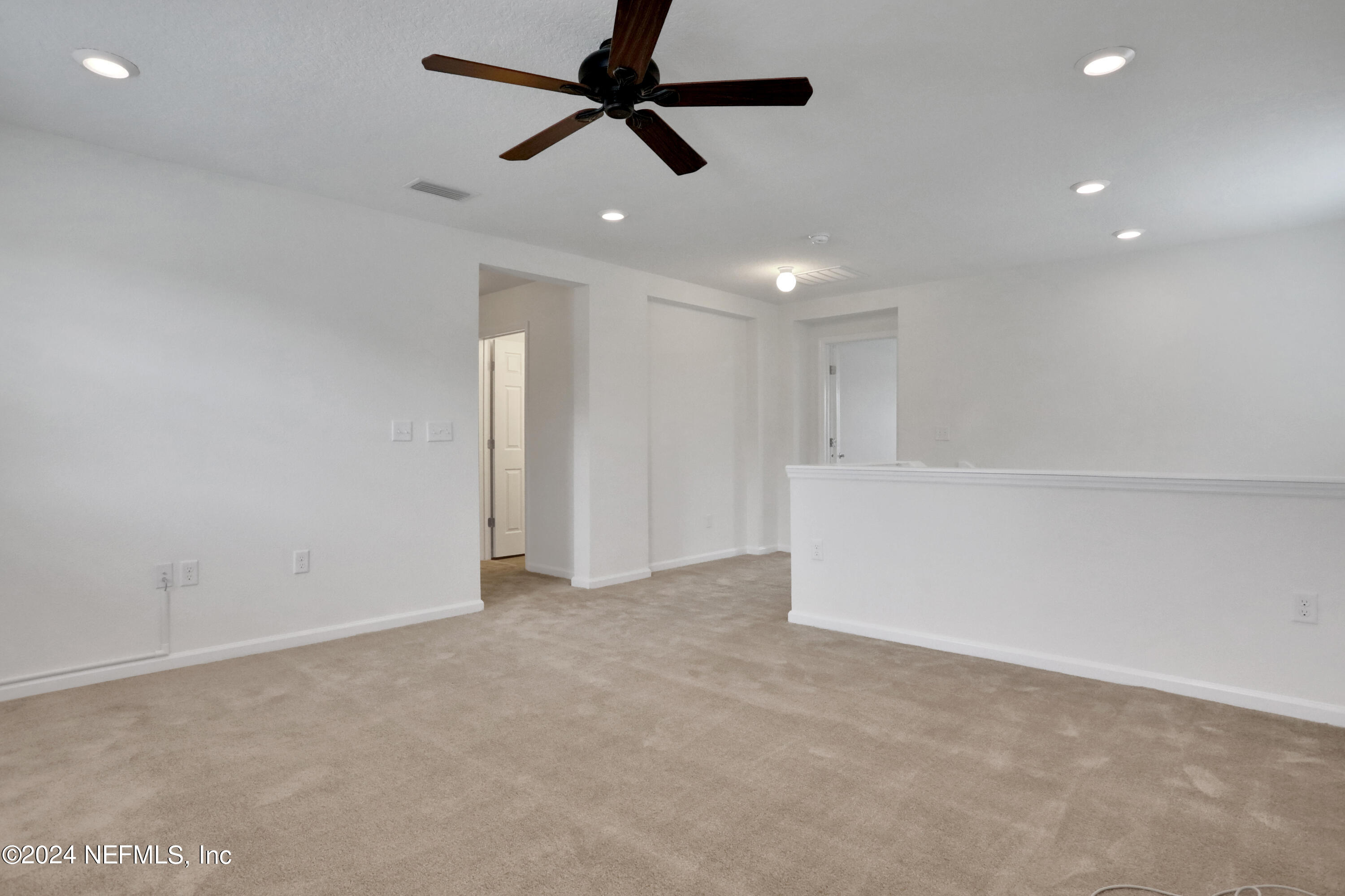 16055 Hutton Lane Jacksonville, FL 32218 - Photo 19 of 28 an empty room with ceiling fan and window