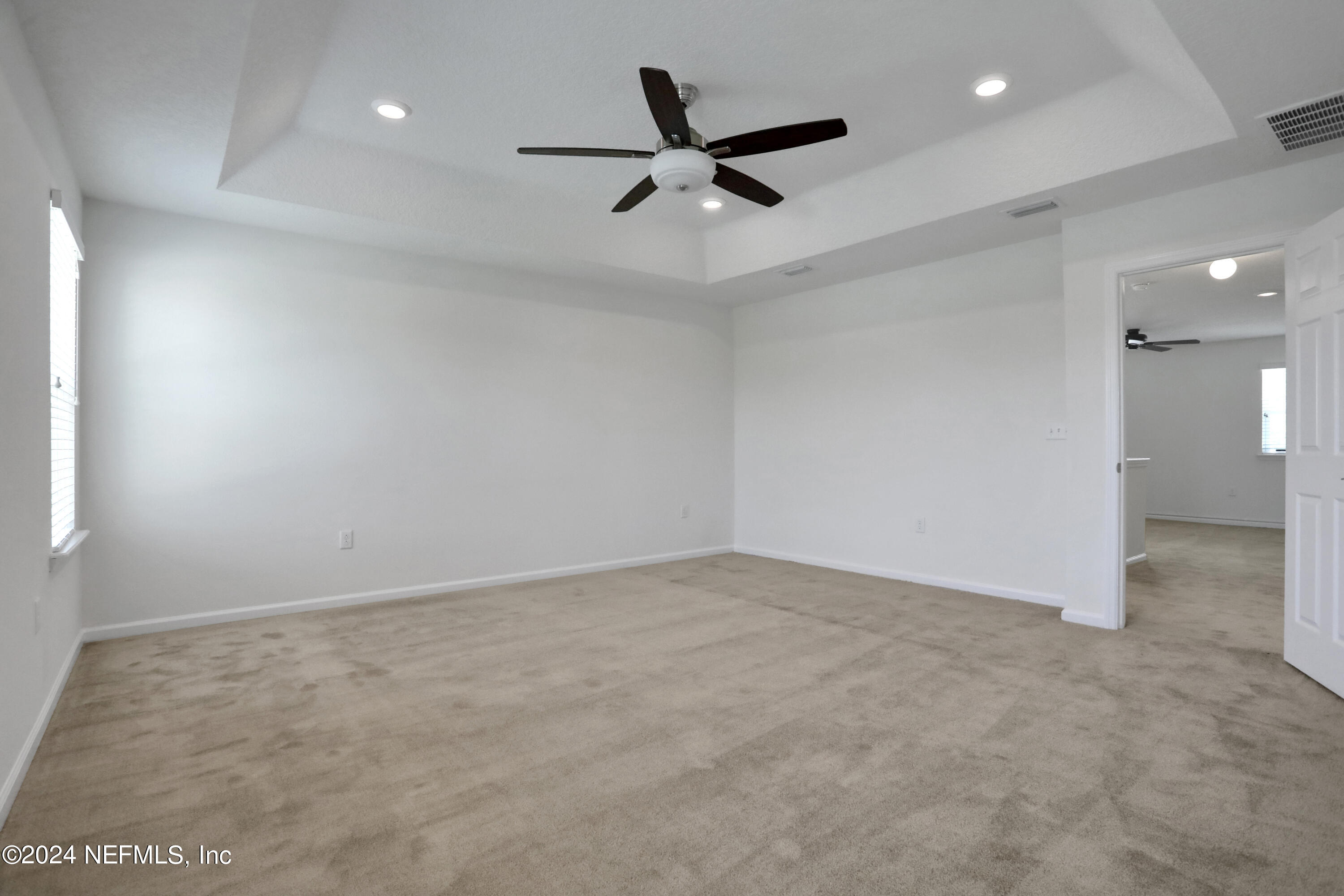 16055 Hutton Lane Jacksonville, FL 32218 - Photo 21 of 28 an empty room with ceiling fan and window