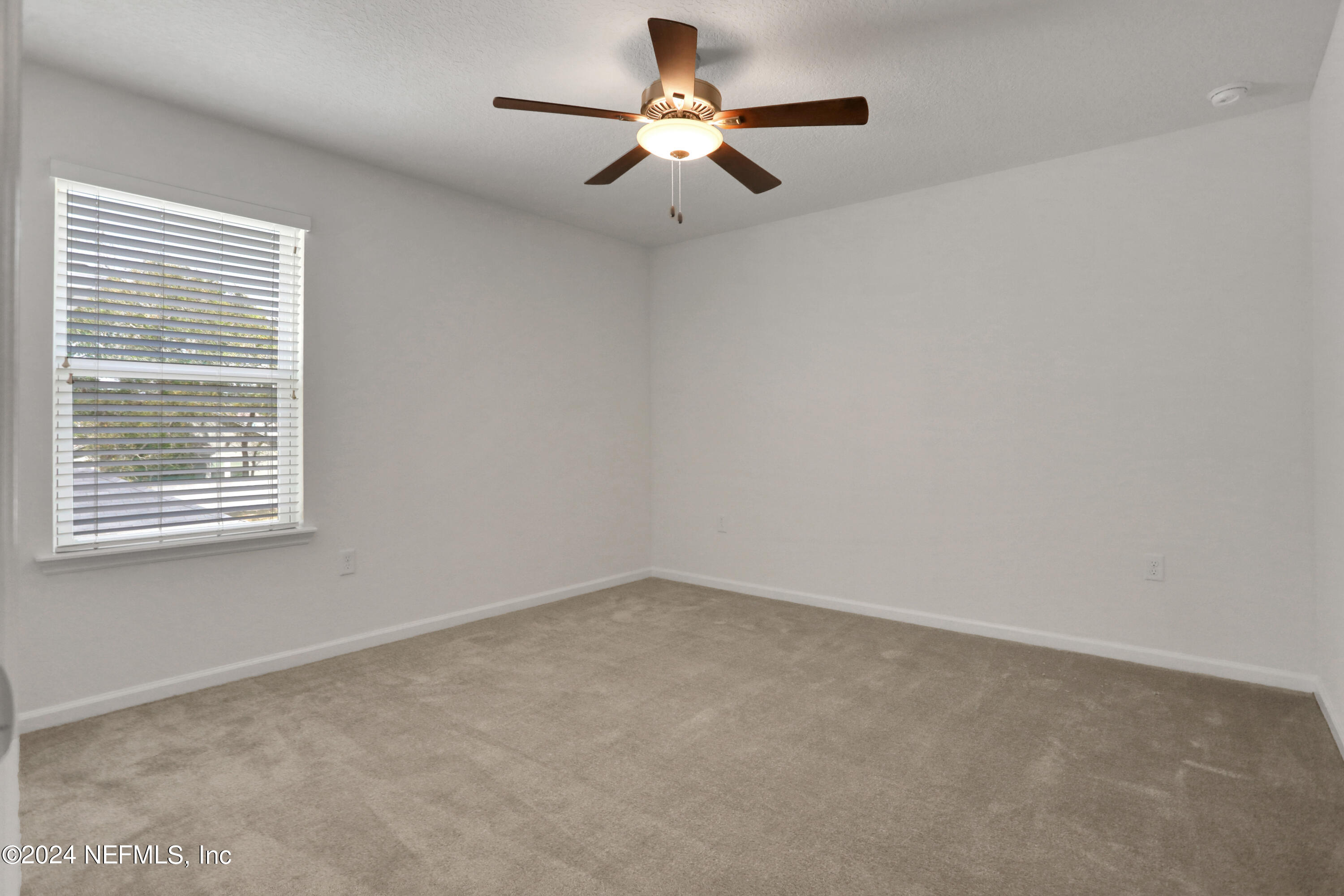 16055 Hutton Lane Jacksonville, FL 32218 - Photo 24 of 28 a view of an empty room with a window