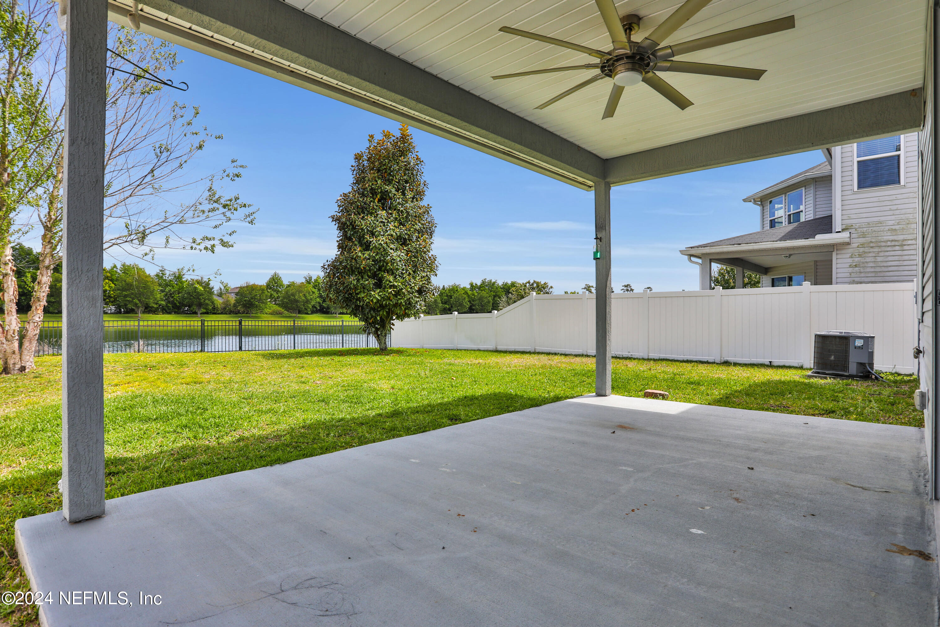16055 Hutton Lane Jacksonville, FL 32218 - Photo 27 of 28 a view of yellow house with a big yard