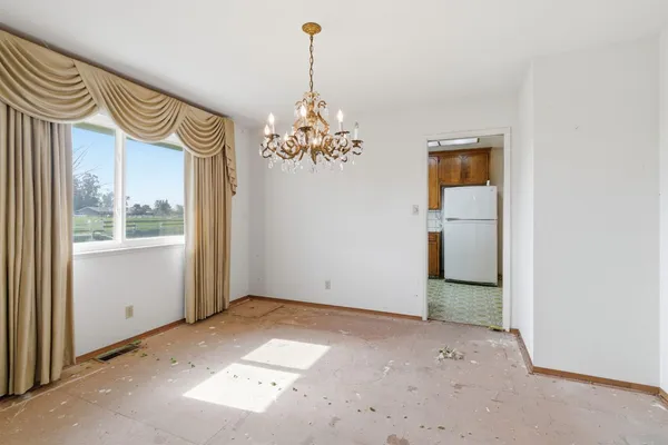 a view of a chandelier in big room and chandelier