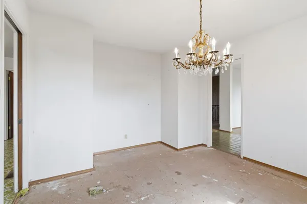 a view of an empty room with floor to ceiling window