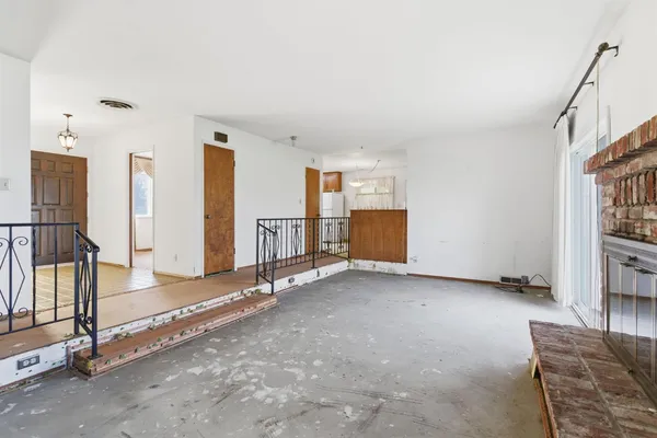 an empty room with furniture and a fireplace